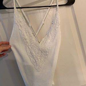 Cross back white body suit